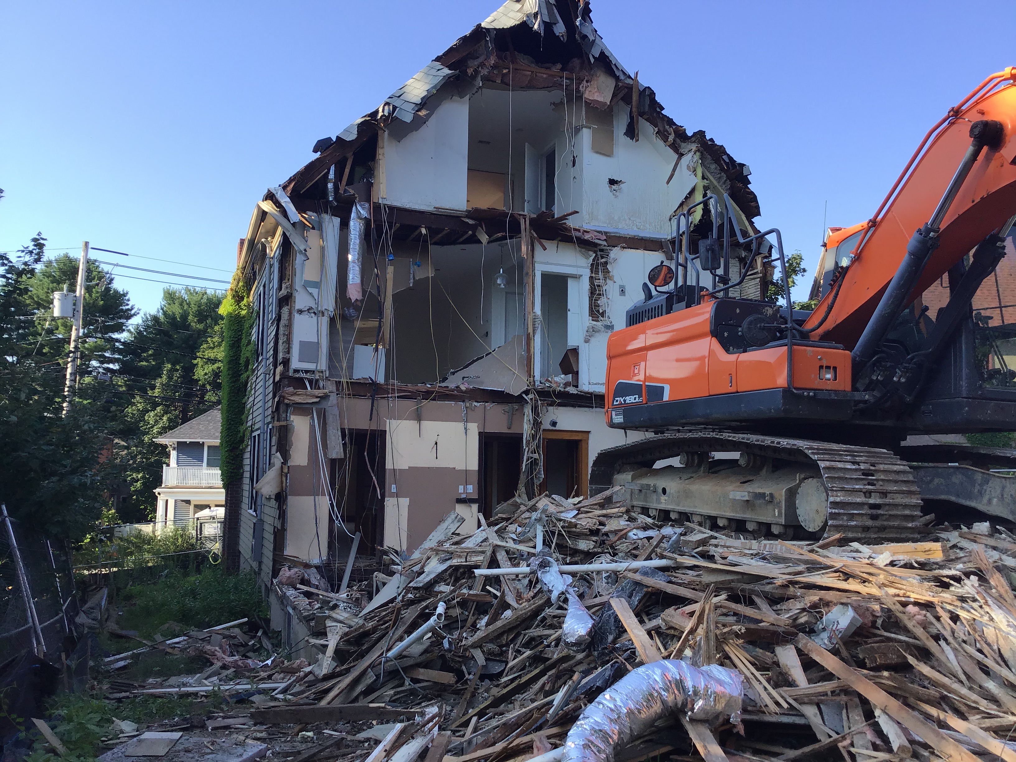 Old garage scheduled for demolition with permit documents in Massachusetts
